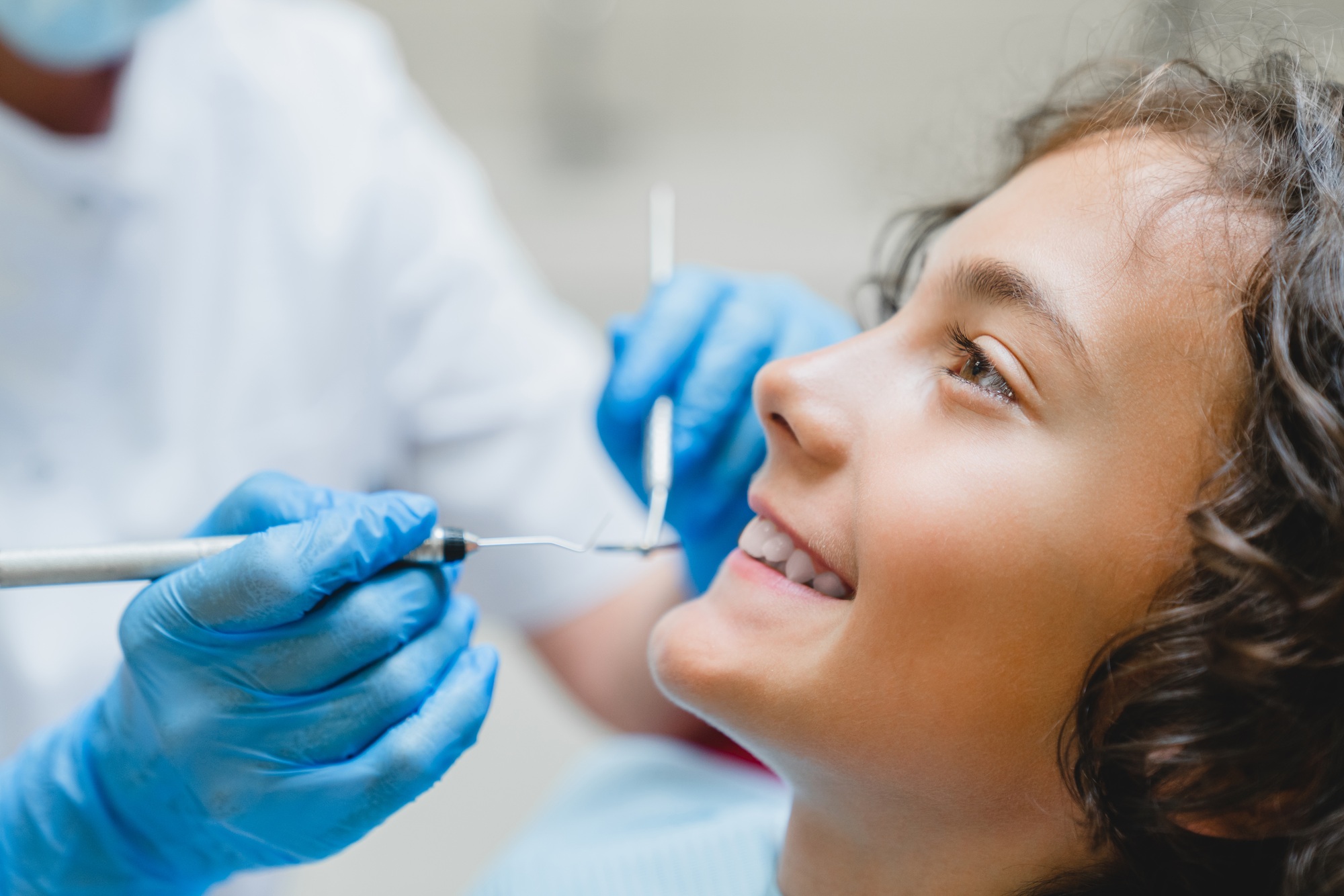 Side portrait of a perfect ideal dreamy smile. Preteen caucasian boy visiting dentist orthodontist